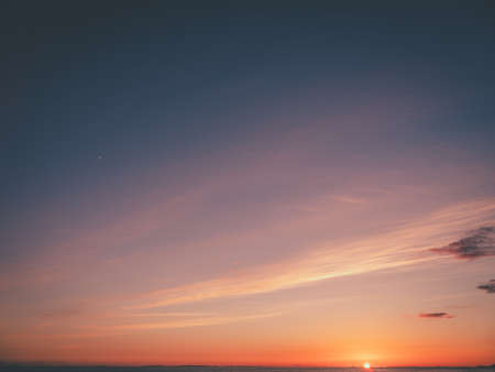 Panorama evening sky with blue, white and orange cloudsの写真素材