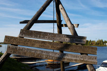 wooden sculpture with a joke about the weather forecast carved on wooden boardsの写真素材