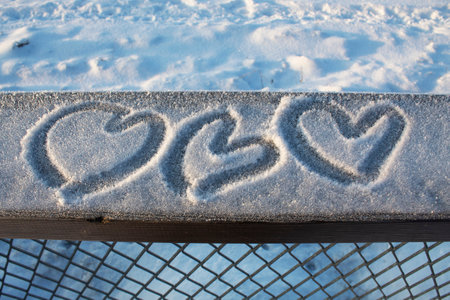 hearts drawn in the snowの写真素材