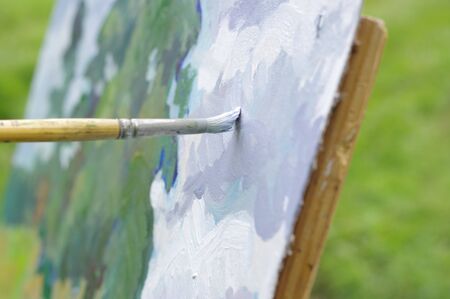 Drawing with oil paints on the nature. Drawing oil paintings of a natural landscape on a white cardboardの写真素材