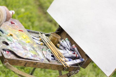 Drawing with oil paints on the nature. Wonderful hobbyの写真素材
