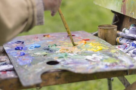 Drawing with oil paints on the nature. Great hobby, leisure and pastime.の写真素材