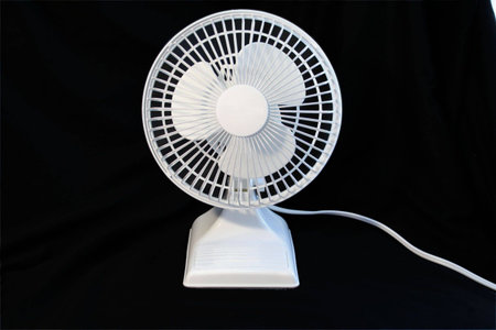 white fan against black background