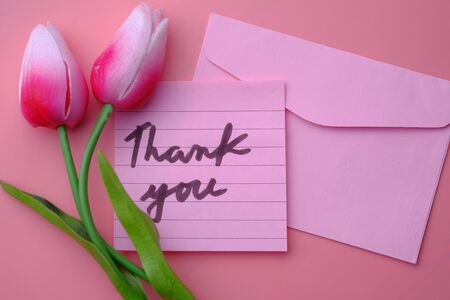 Close up of thank you note with tulip flower .の写真素材