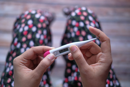 top view of women hand holding thermometer