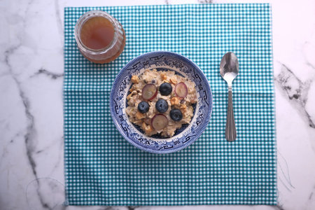 top view of oat meal and honey on table.
