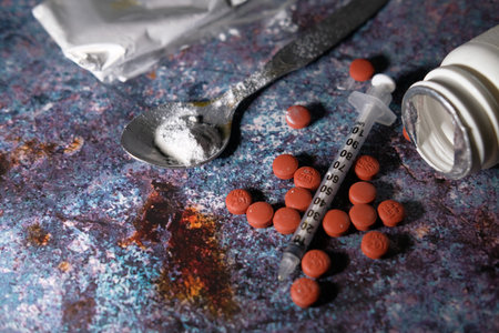 top view of red pills and syringe on table