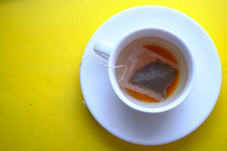 top view of green tea on yellow backgroundの写真素材