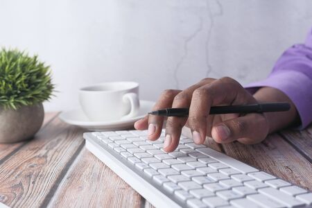 man hand typing on keyboard on office desk.の写真素材