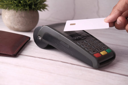 man hand contactless payment by credit card at cafe