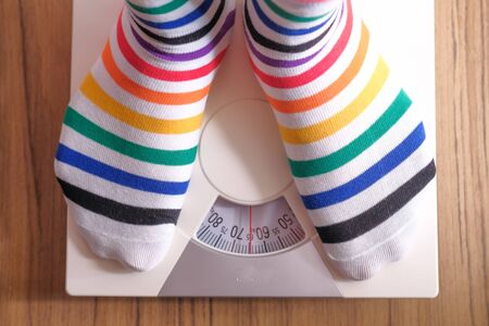 top view of women feet measuring weight on scale .の写真素材