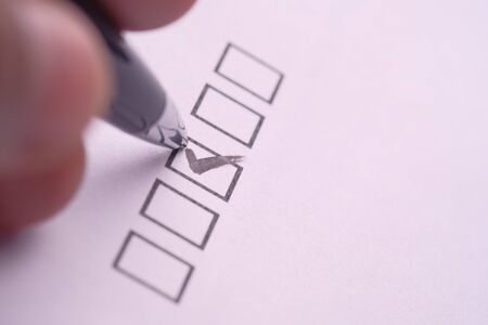 Close up of man hand tick mark on boxの写真素材