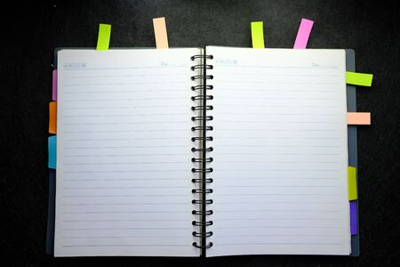top view of open notepad on black background.の写真素材