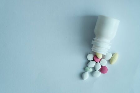 top view of pill spilling from container.の写真素材