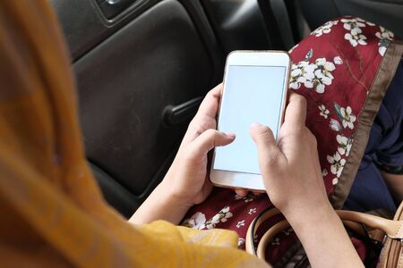 Close up of women use smart phone in car.の写真素材