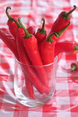 Close up of red chili in a jar on table.の写真素材