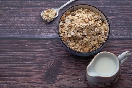 top view of oats in a bowl with milk on table .の写真素材