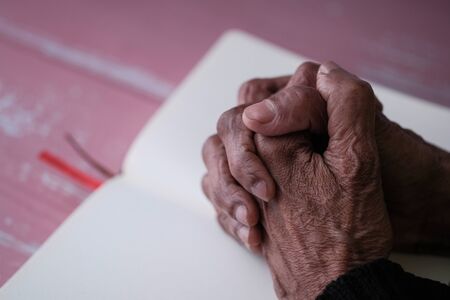 Close up of senior women hand on a book .の写真素材