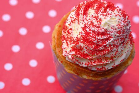 Close up of cup cake on red background.の写真素材