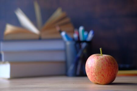 Close up of apple and book on tableの写真素材