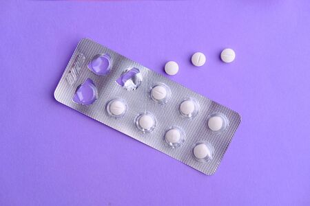 top view of white pills on color background.の写真素材