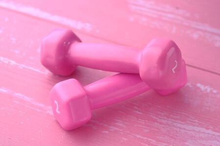 Close up of pink color dumbbell on tableの写真素材