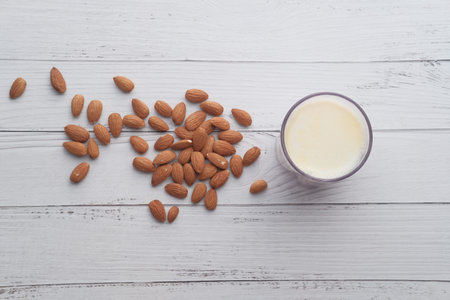 top view of almond and milk on table.