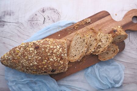 Close up of bread on chopping board on table .の写真素材