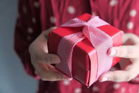 Closeup of women hand holding gift boxの写真素材