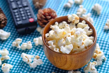 top view of popcorn and tv remote on tableの写真素材