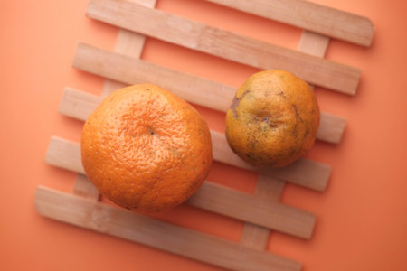 Close up of fresh and ripe orange on orange backgroundの写真素材