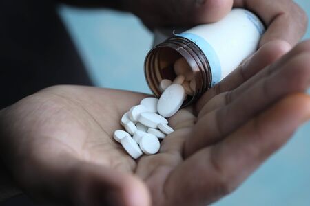 close up of person hand taking pillsの写真素材