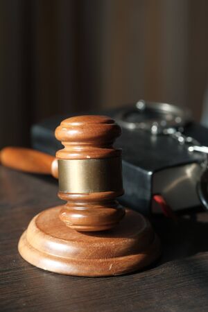 close up of gavel, cash and book on table.の写真素材