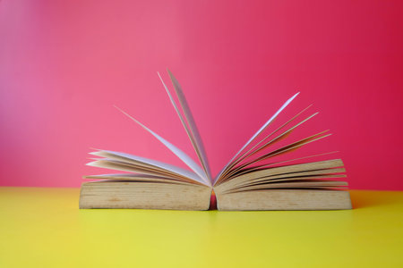 Close up of open book on color background, 