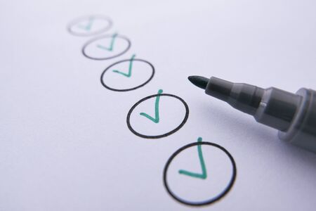 close up of check mark with pen on paper.の写真素材