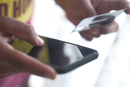 Close up of man hand paying by credit cardの写真素材