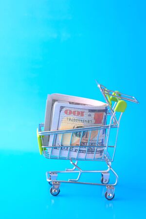 100 dollar cash in shopping cart, close up .の写真素材