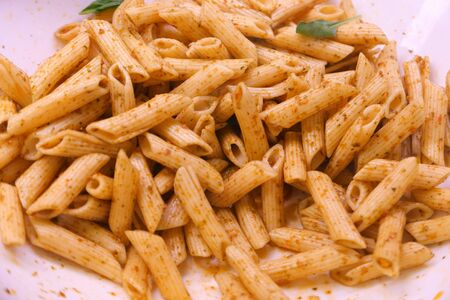 cooked pasta in a plate for dinner, close up.の写真素材