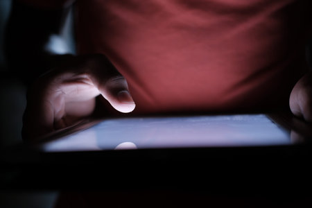 Close up of man hand use digital tablet at night