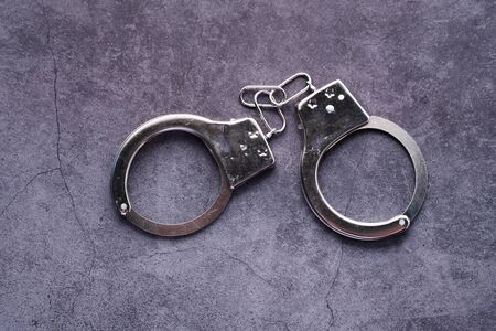 top view of handcuff on black background, crime conceptの写真素材