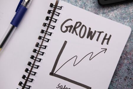 growth chart on notepad with pen on table.の写真素材