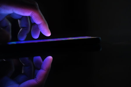 Close up of man hand use smart phone at night.