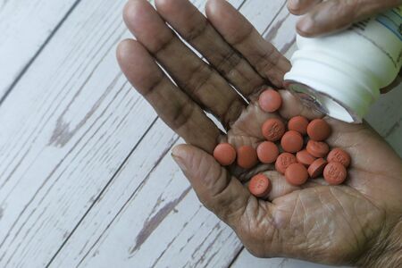 Close up of pain killer on senior women handの写真素材