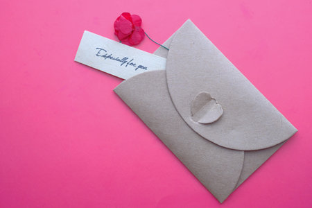 Close up of valentine day envelope on red background.