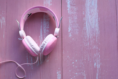 top view of pink color headphone on pink table