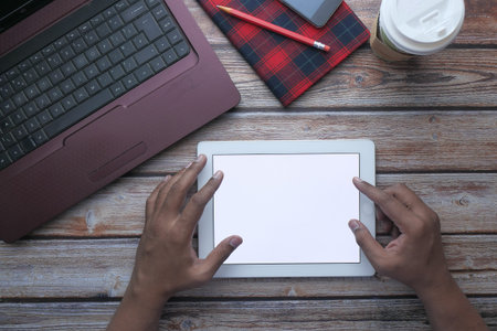 top view of man hand use digital tablet on office desk