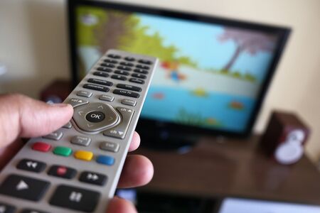 Close up of man hand use tv remoteの写真素材