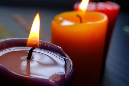 Close up of colorful burning candle at nightの写真素材
