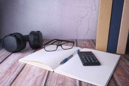 top view of coin, calculator, wallet and notepad on tableの写真素材