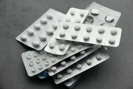 close up of stack of white pills on black backgroundの写真素材